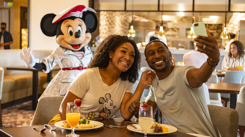 Couple taking selfie with Minnie Mouse