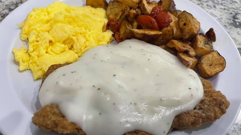 Country fried steak with gravy and eggs