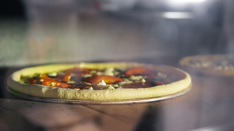 Restaurant convection oven cooking pizzas