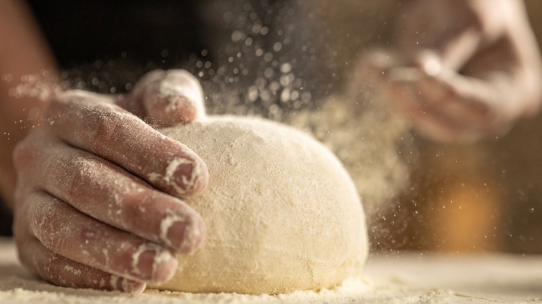 Ball of dough getting floured 