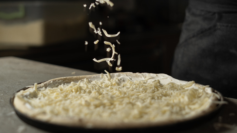 Shredded cheese topped on pizza