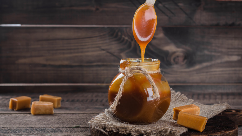 butterscotch on wooden table with butterscotch in a jar