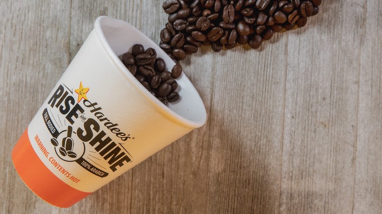 Hardee's coffee cup and beans