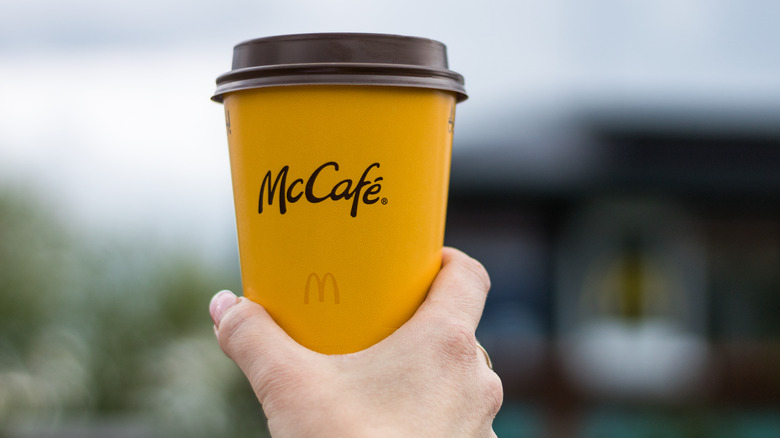 hand holding McDonald's McCafe coffee