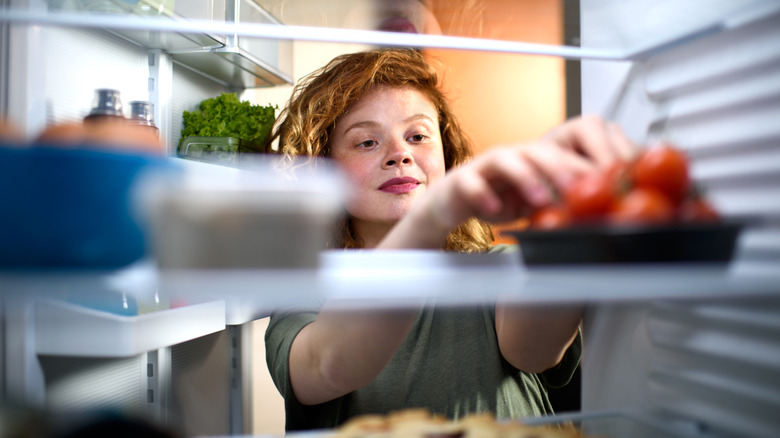 child reaching into kitchen