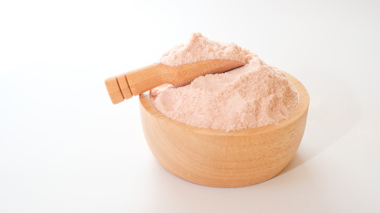 wooden bowl of pink salt