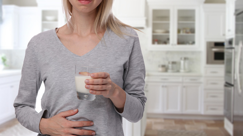 Woman holding stomach