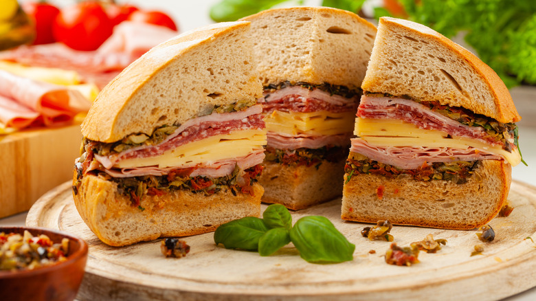 sliced muffuletta sandwich on board