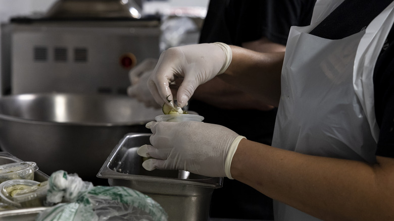 A cook portioning pickles