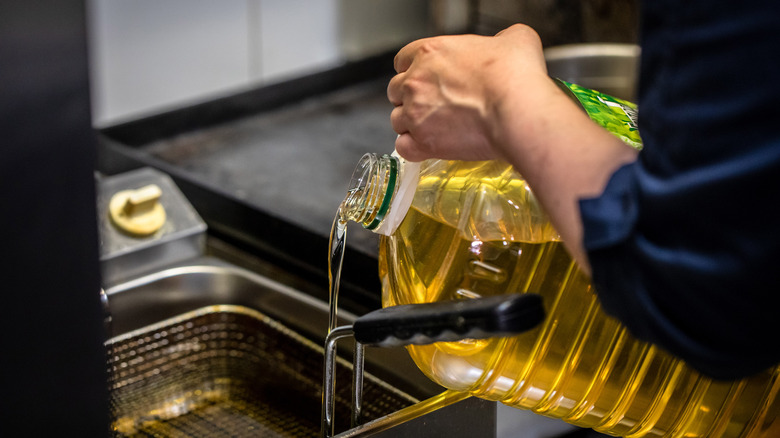 Oil being poured into fryer