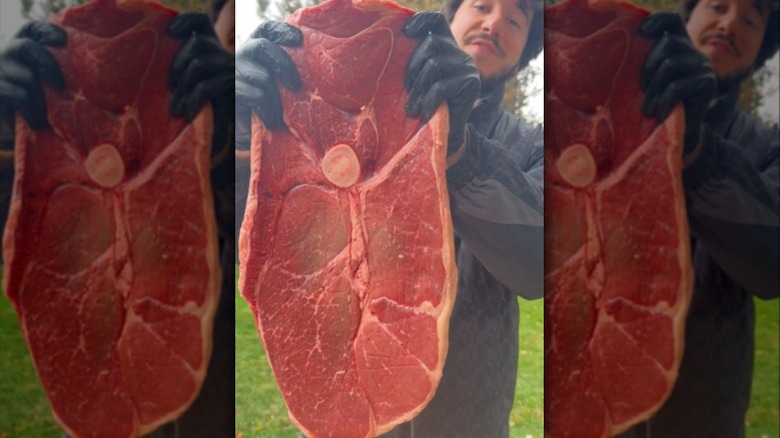 Man holding raw Tom and Jerry Steak