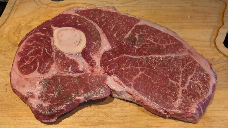 Raw Tom and Jerry Steak on wooden cutting board