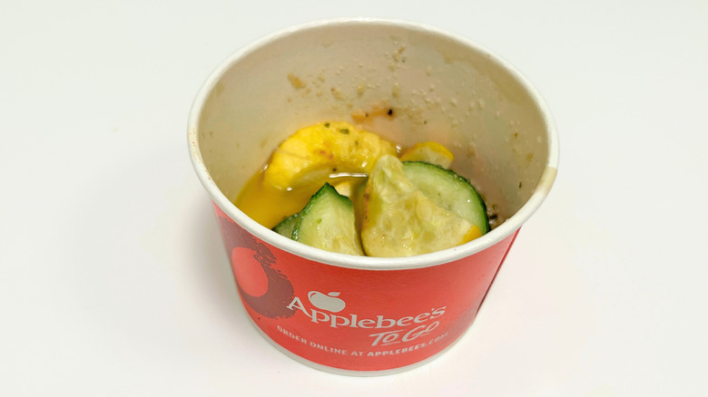 A to-go container of Applebee's Sauteed Zucchini and Yellow Squash