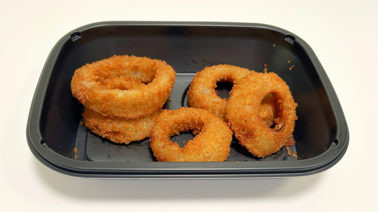 A to-go container of Applebee's Onion Rings