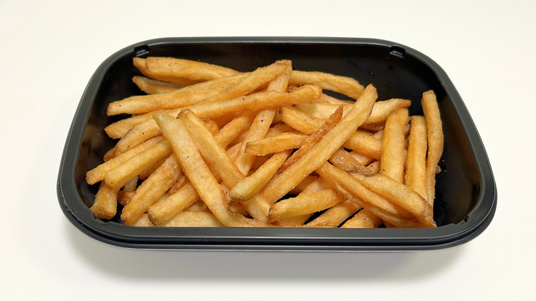 A to-go container of Applebee's Basket Fries