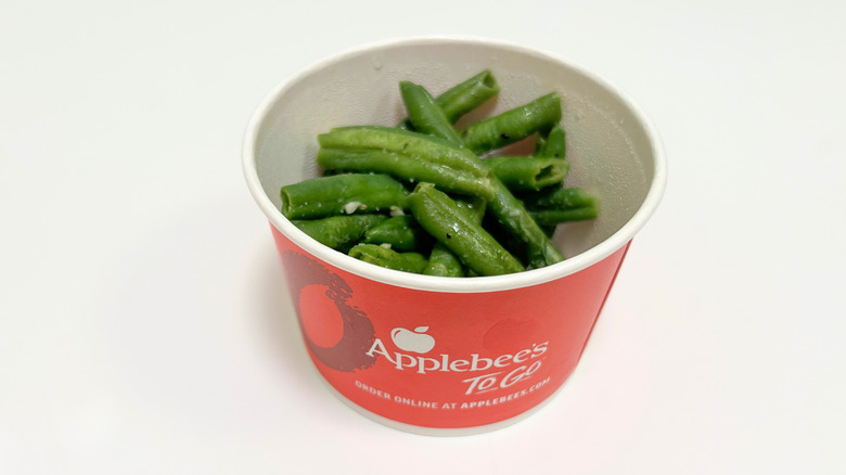 A to-go container of Applebee's Garlicky Green Beans
