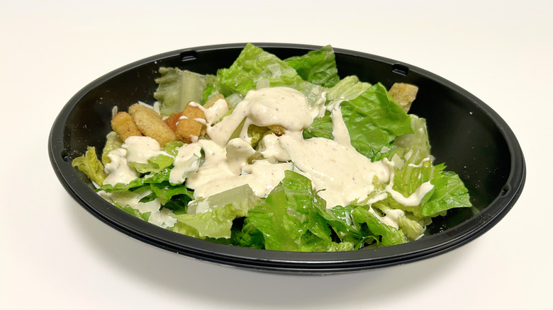 A to-go container of Applebee's Caesar Salad