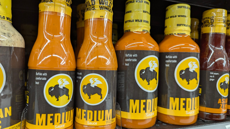 a row of Buffalo Wild Wings' sauces on a grocery store shelf
