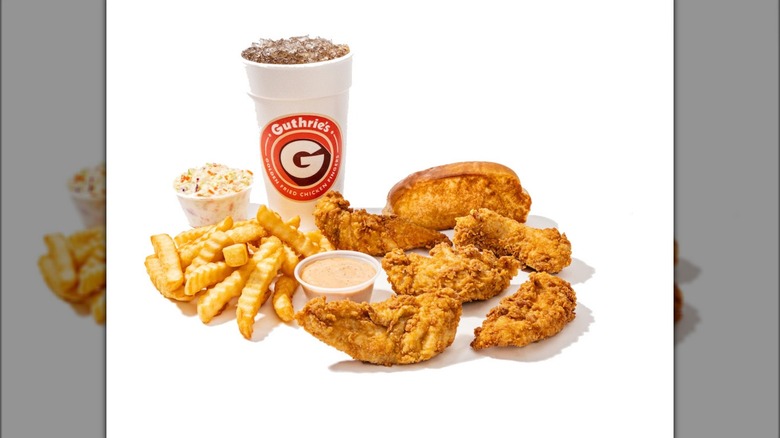 a platter of Guthrie's food, including tenders, fries, slaw, and a drink