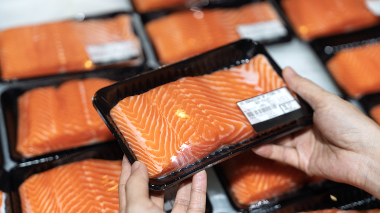Woman shopping for salmon filets