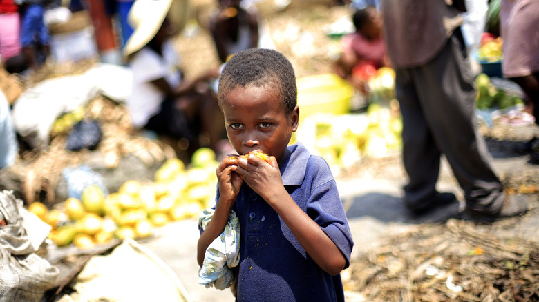 Haitian boy eating