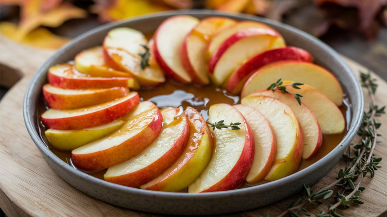 Sliced apples arranged in ring inside baking dish