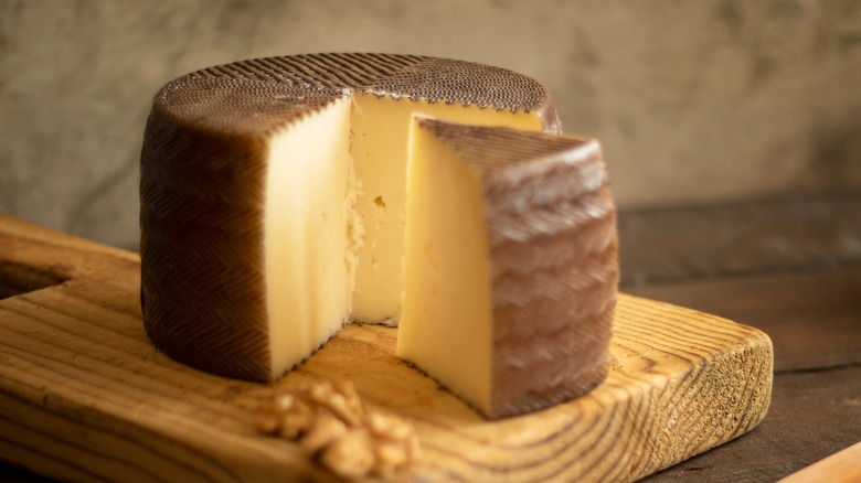 Manchego cheese on wooden board