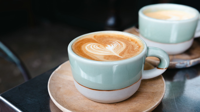 Two cups of cappuccino with heart-shaped latte art