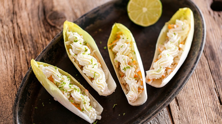 Endive cups with filling on tray
