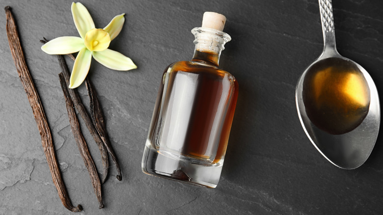 Vanilla beans and flower with bottle and spoon