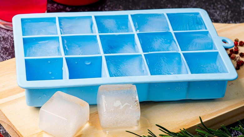 A blue silicone ice try with ice cubes