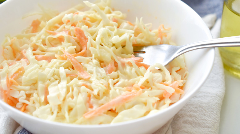 cabbage and carrot coleslaw with a fork