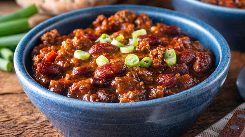 Bowl of chili with scallions