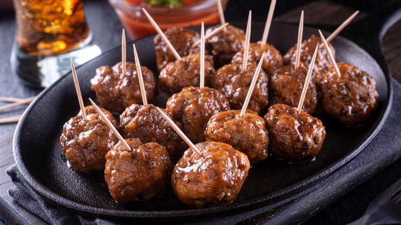 cocktail meatballs with toothpicks on skillet