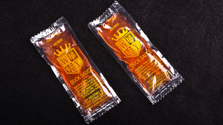duck sauce packets on black cloth