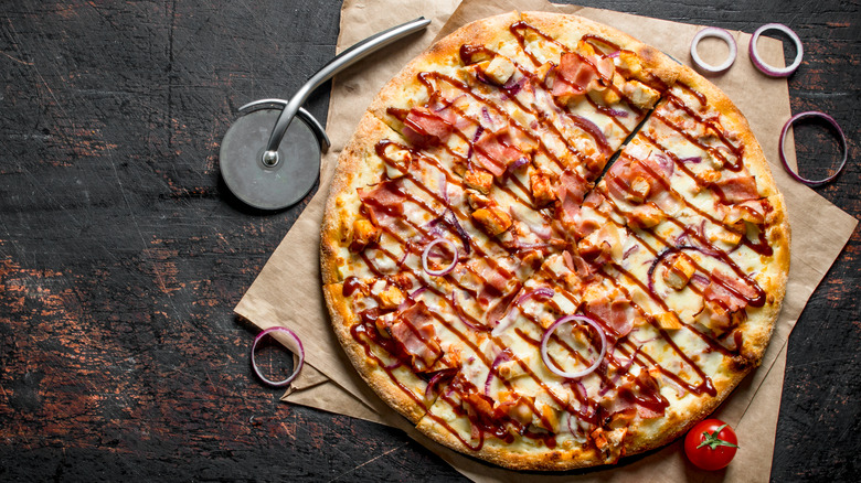 BBQ pizza sliced by cutter