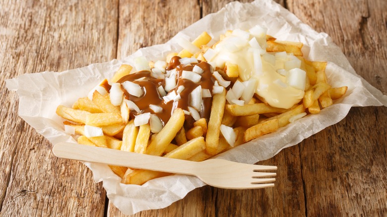 basket of fries with toppings and fork