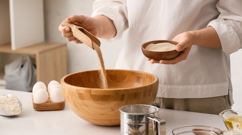 Adding dry yeast to bowl 