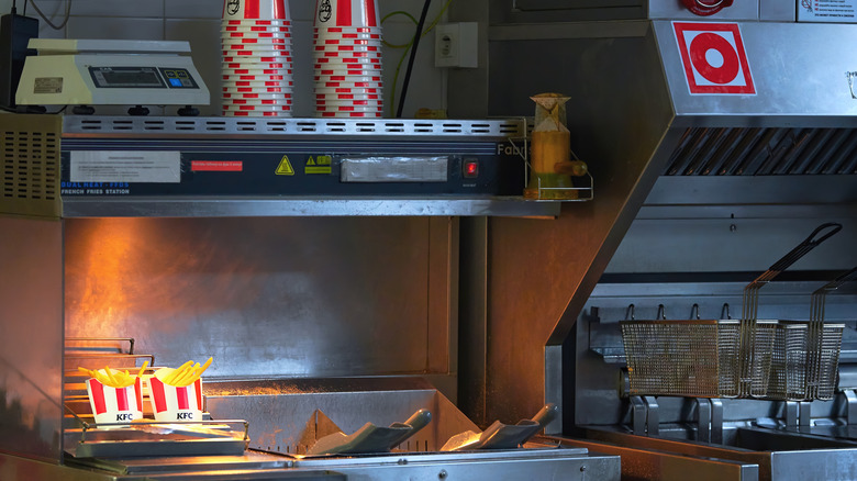 Deep fryer filled with boiling oil in a KFC kitchen.
