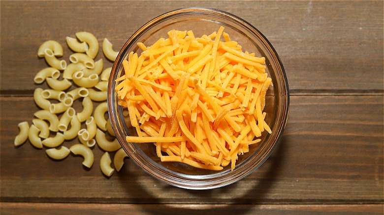 Bowl of cheese with raw macaroni 