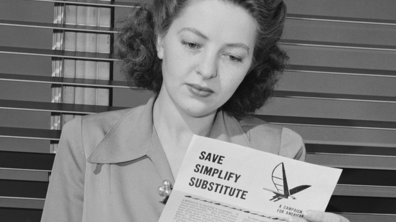 woman reading WWII ration pamphlet
