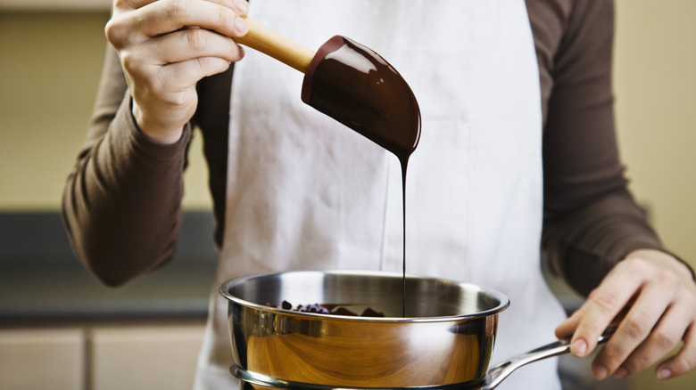 Person mixing melted chocolate