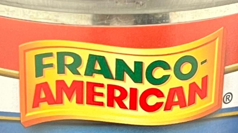 Closeup of a Franco-American logo on a can. A green "Franco-" is on top of a red "American" on a yellow label