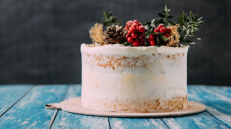 naked vanilla cake with holiday garnish