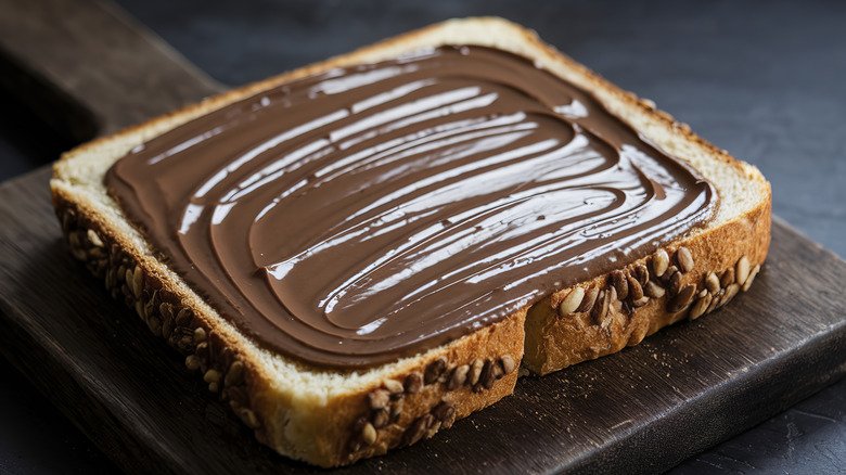 A slice of bread with the entire surface evenly smeared with cacao butter