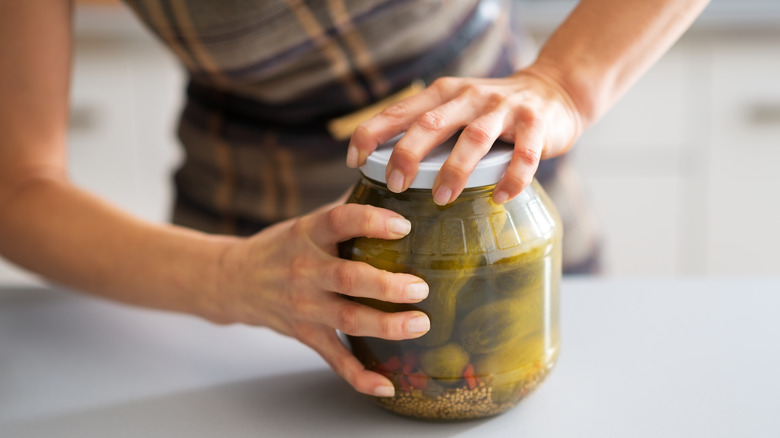 trying to open a jar of pickles