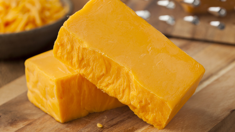 Block of bright orange cheddar cheese