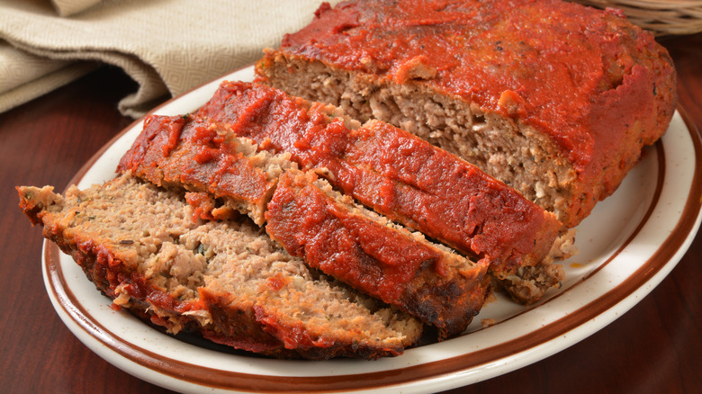 Sliced meatloaf on white dish