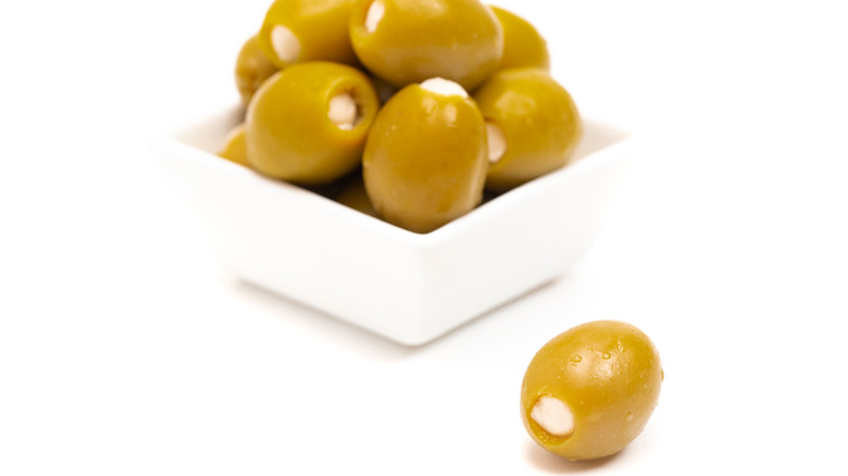 Green olives stuffed with cheese on a white background.
