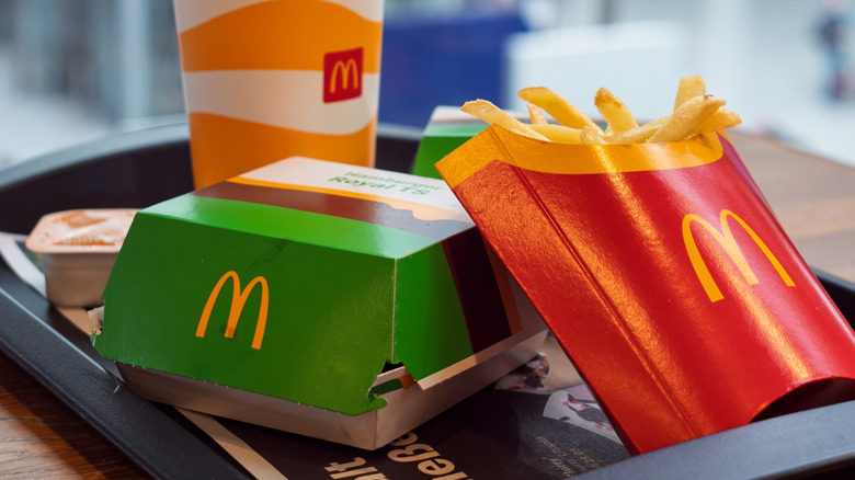 McDonald's meal including burgers, fries, and a drink on a tray.